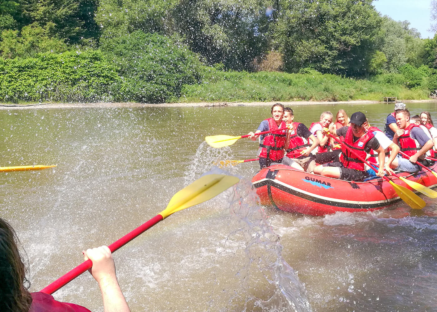 Optional activity, a group of people on a raft along the Mura River